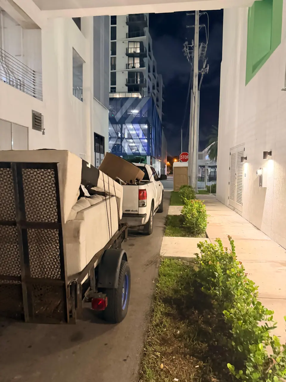 Pickup truck and utility trailer loaded for a residential hauling and delivery job in Miami-Dade